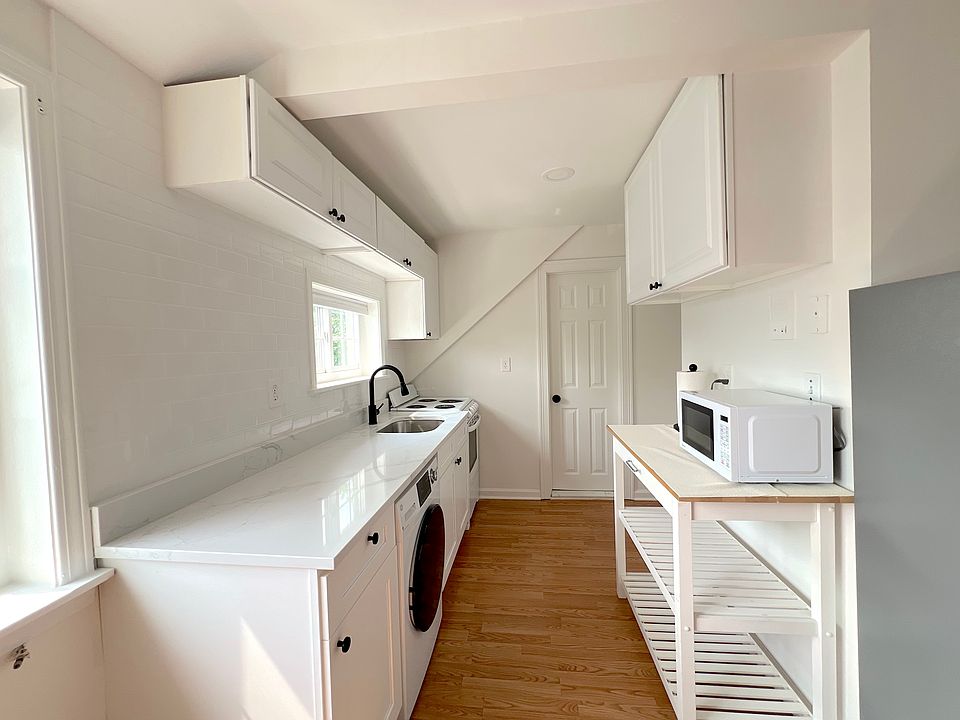 Newly remodeled kitchen with added washer dryer and quartz countertops