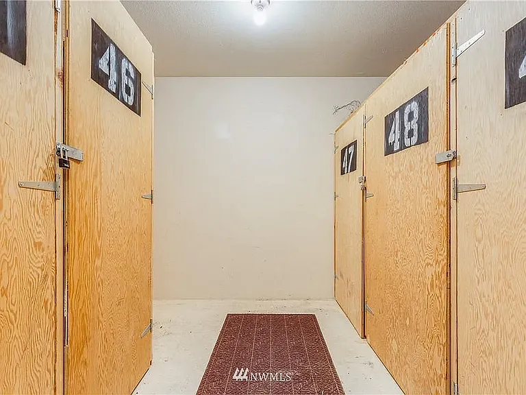 3x3x5 ft storage and/or bicycle locker located across the interior hallway from the unit.