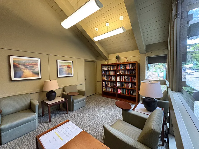 A library featuring numerous titles, plus a quiet space to read them
