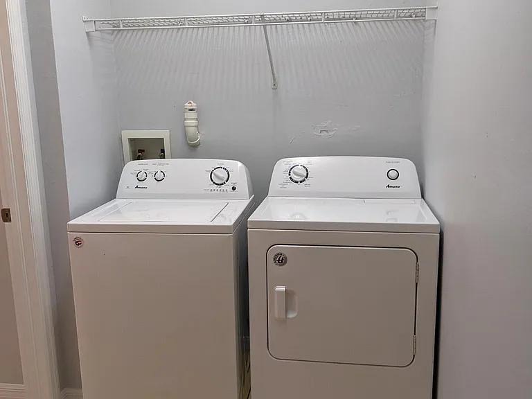 large laundry room with additional storage in back