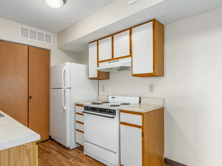 Kitchen of a River Valley apartment home in Lancaster, OH, with cabinets, stove, oven, refrigerator.