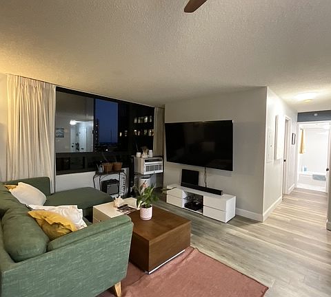 living room and hallway to bedroom and bathroom, tv and furniture included
