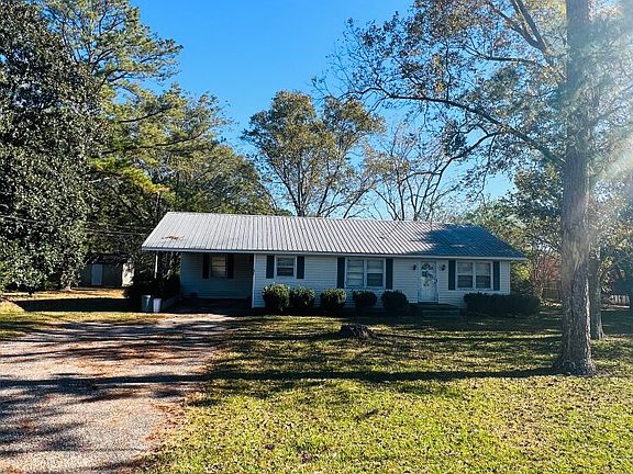 Nice long paved drive way and carport!