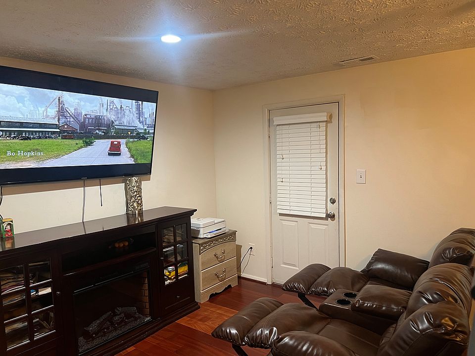 Basement Bedroom #4 with Roku 65" 4k HDTV, Double Recliner Sofa, Treadmill, Queen Bed, Dresser and Mirror