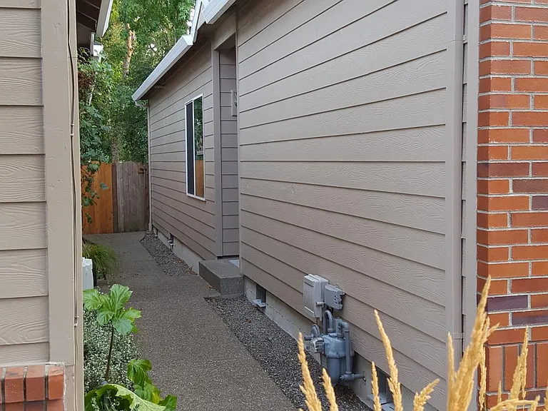 Side of house and path to main entrance.