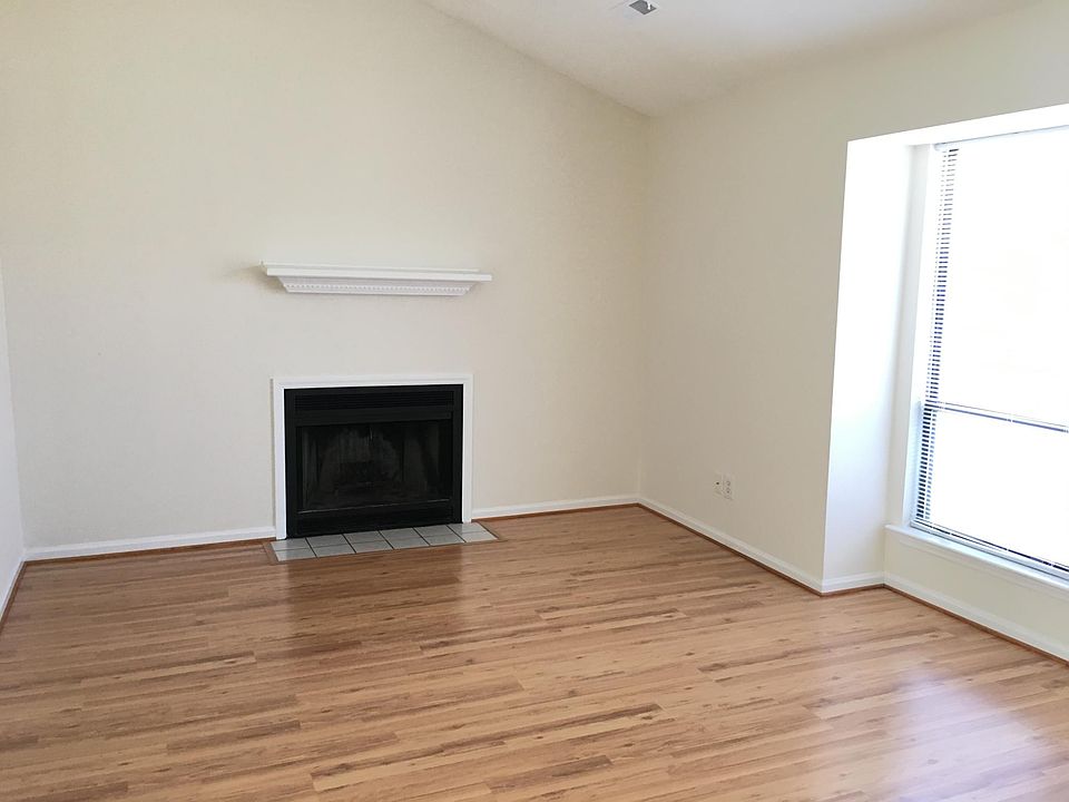 living room with vaulted ceiling and bay window