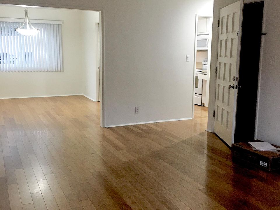 Living Room showing front door entrance and Full Dining Room, Kitchen off to the right