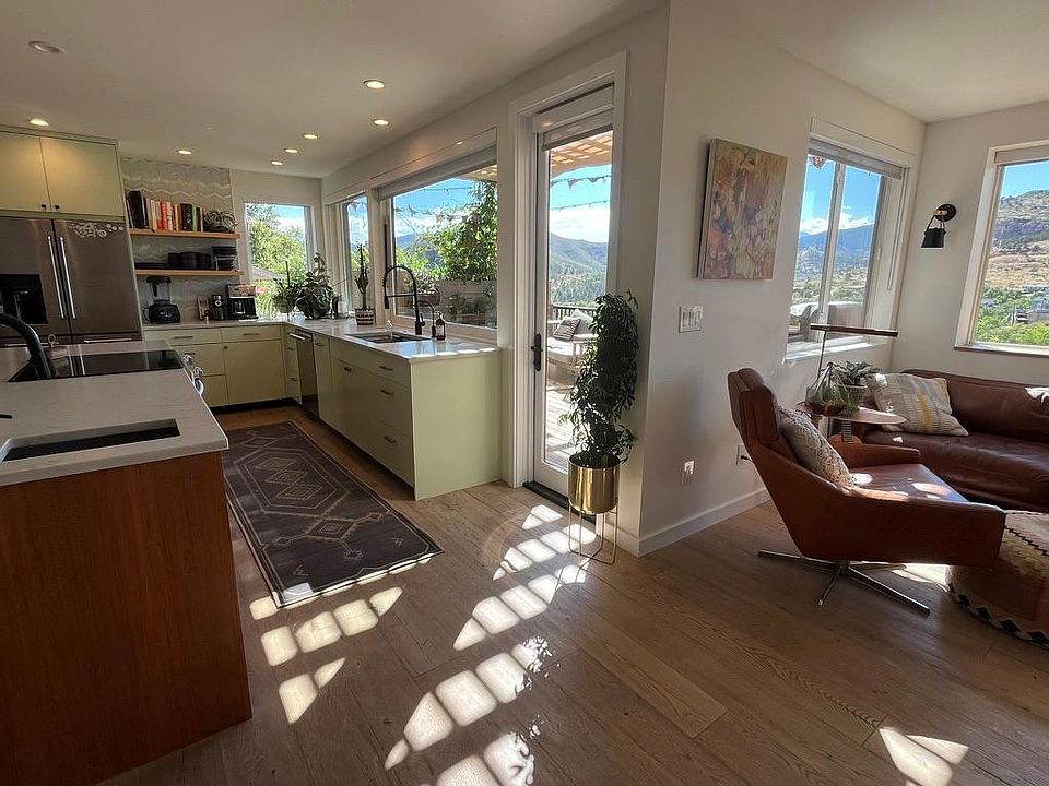 View of open floor kitchen and cozy reading nook. All modern updated applicances, white oak flooring. spacious teak kitchen island, induction stovetop.