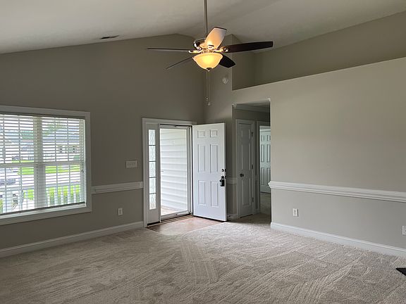Living Room with tall ceilings and ceiling fan!