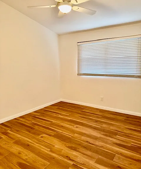 Spacious third bedroom overlooking the backyard, featuring an extended closet for added storage and convenience."
