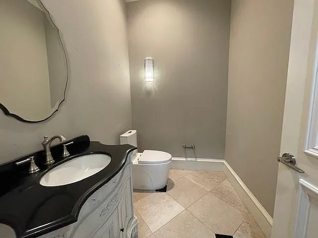 Bathroom with vanity and light tile patterned floors