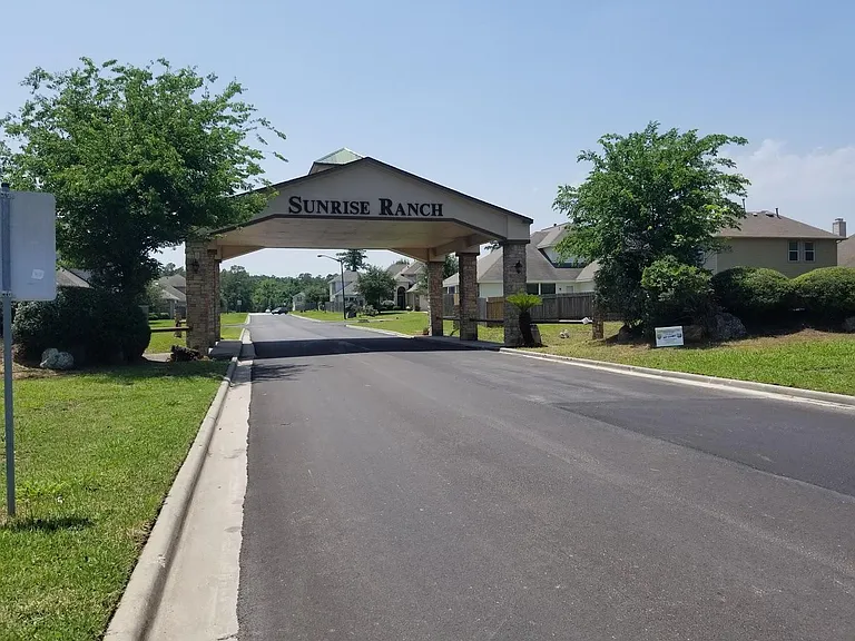 Sunrise Ranch entrance bridge restricts oversized vehicles. The new HOA is revitalizing neighborhood with fresh paving and landscaping.