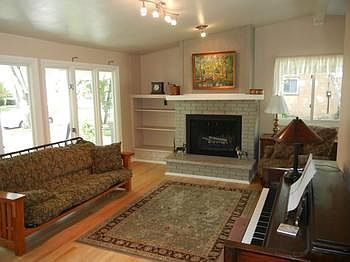 Spacious living room with nice hardwood floors, fireplace, and vaulted ceilings.