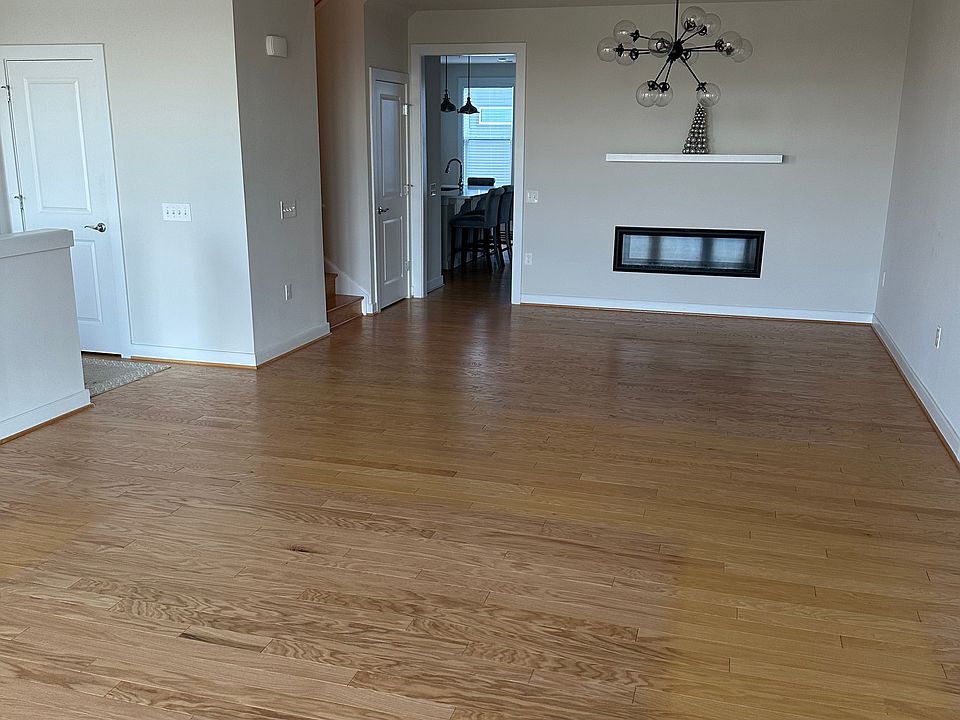 Living room & dining open area with modern light fixture and fireplace