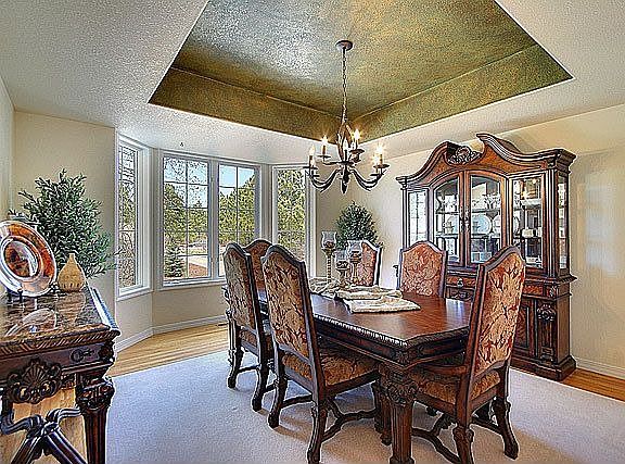 Separate formal dining room with custom painted coffered ceiling