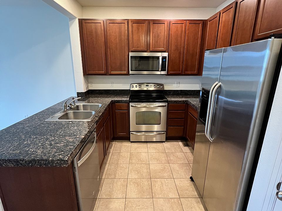 Kitchen with Granite Countertops and Cherry Cabinets. All Stainless appliances. Dishwasher, Fridge, Oven and Microwave.