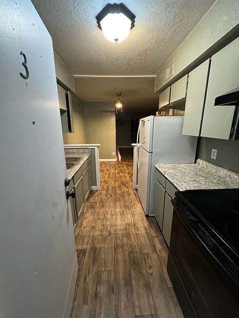 Entry into kitchen from back door. Notice new flooring with remodel.