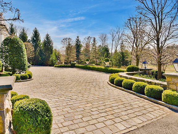 Arrive in Grand Style. Impressive Belgian Block Front Courtyard, Exquisitely Landscaped With Old World Gas Lanterns and Stone Retaining Walls.