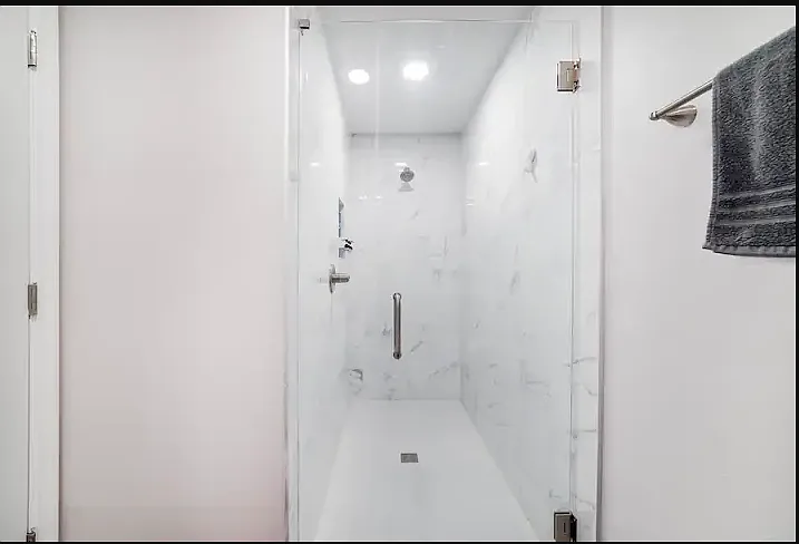 Modern tile shower downstairs in the full ensuite bath.