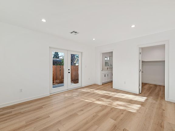 Primary suite, French doors to private patio, walk in closet