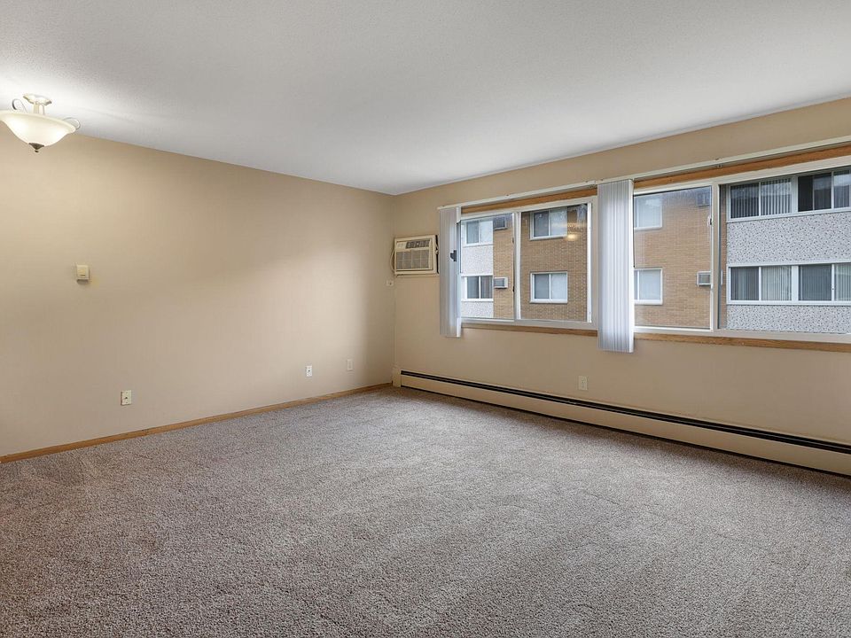 Living room with wall unit air conditioning