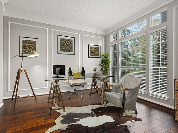 Recent home renovations throughout main floor include this beautiful rich hardwood flooring in large study with floor to ceiling windows and French doors.