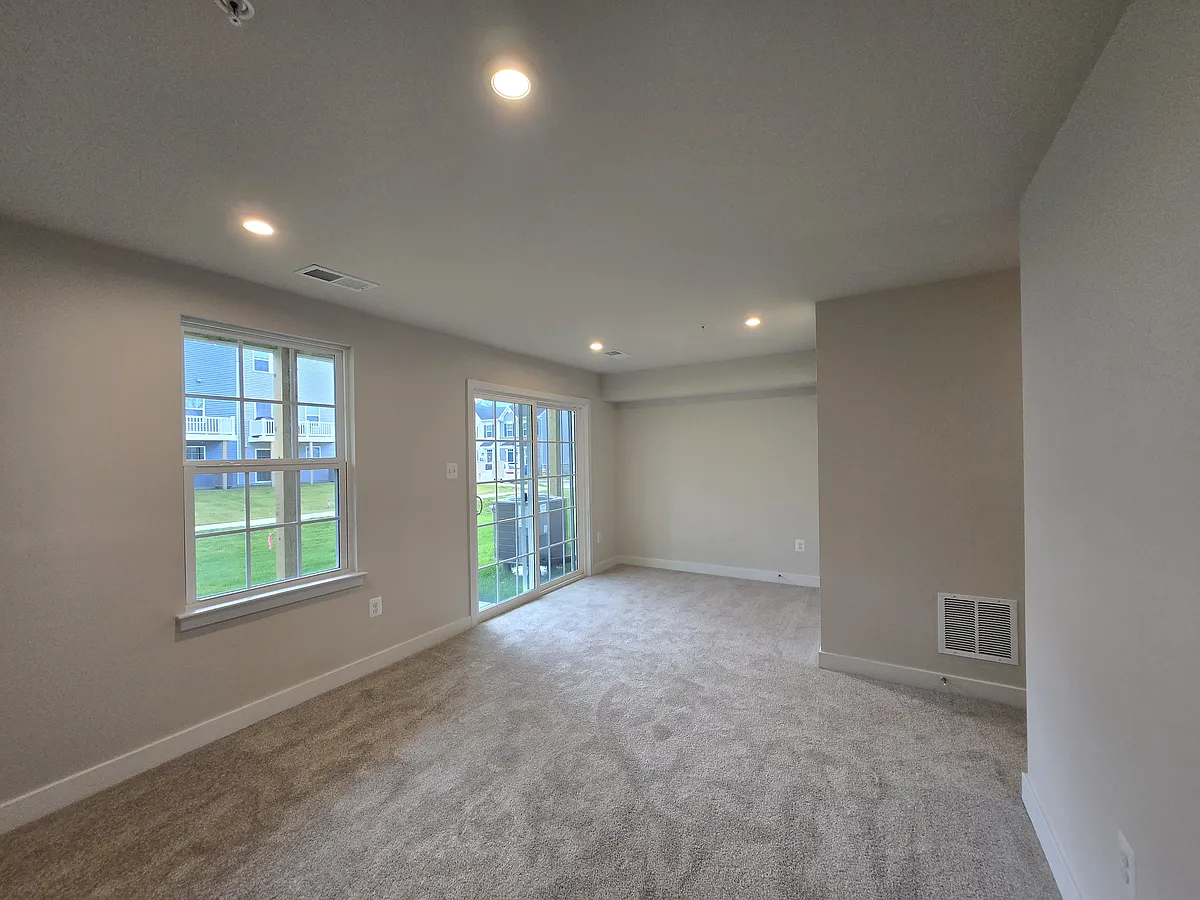 main floor living room that leads to back yard - 14 Chesapeake Ln