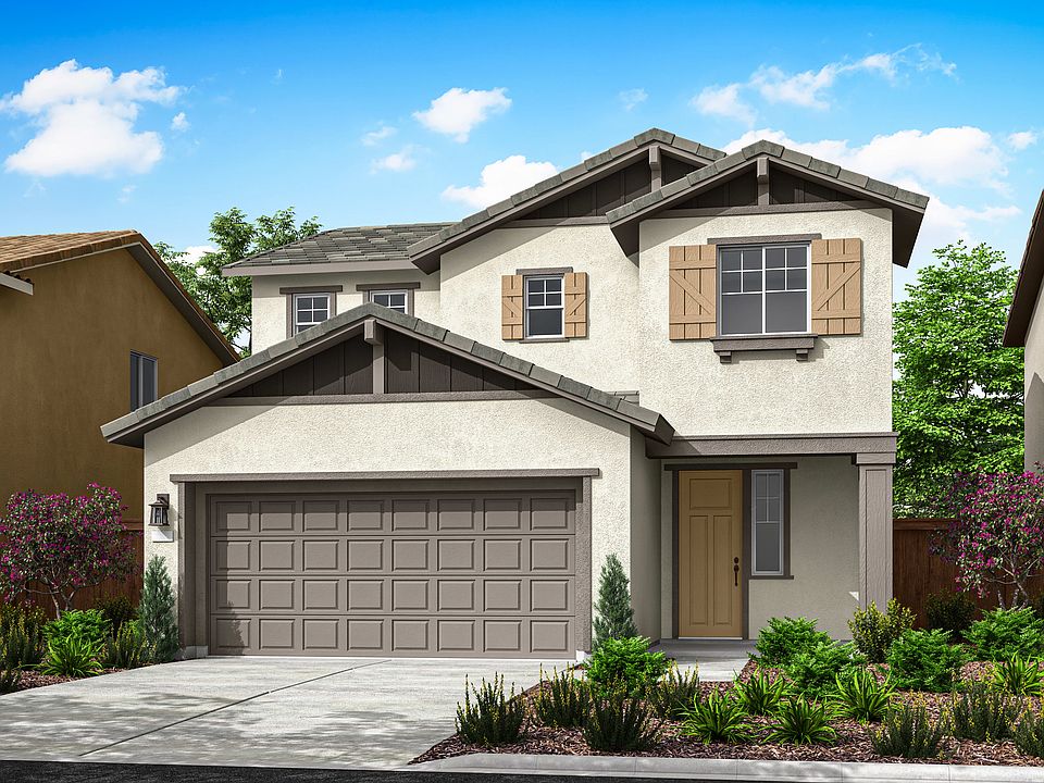 A two-story residential house with a garage, surrounded by lush greenery and a clear blue sky with f