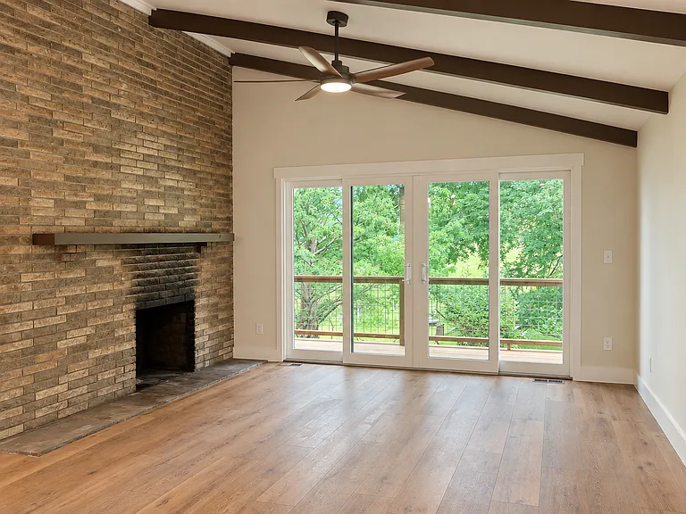 Dramatic vaulted ceilings with floor to ceiling wood burning fireplace. Abundant natural light comes from a stunning 10-foot glass door leading to the covered deck.