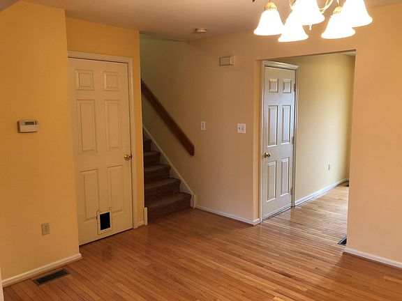 Dining room with view of basement door (cat door), door to garage and foyer entrance.