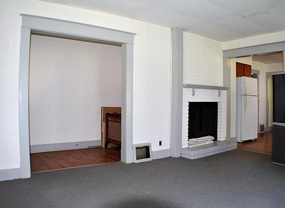 The front foyer leads into the spacious living room with wood burning fireplace