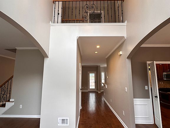 Foyer Hall with Living Room on Left, Dining Room on Right and Family Room in the Back Left.