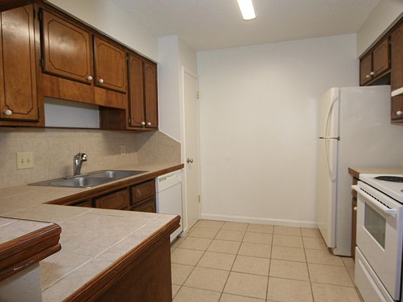 Open kitchen with tons of of cabinet space, all matching appliances and a pantry