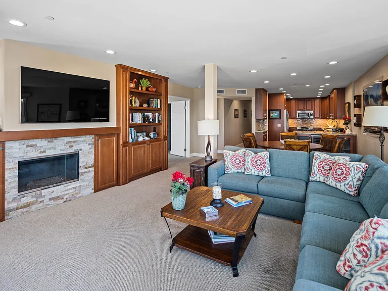 Fireplace, built-in bookcase and large screen TV.