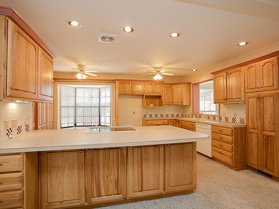 Beautifully updated Kitchen boasts gorgeous cabinetry with custom organizers, roll out shelving and tons of storage. 