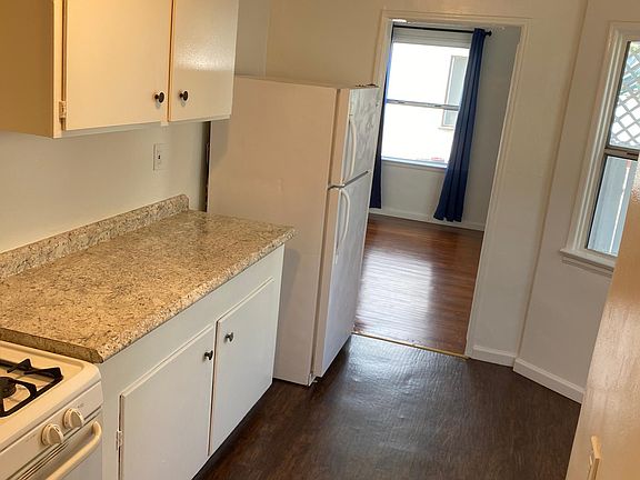 Kitchen alcove with three windows overlooking patio and yard.