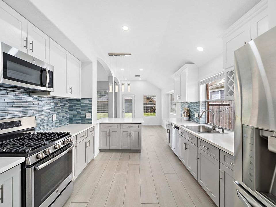 Remodeled kitchen features stainless steel appliances, quartz countertops, natural lights and more