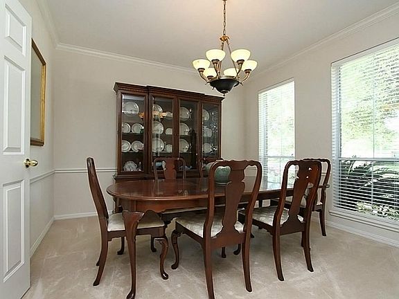 Elegant Formal Dining Room features a beautiful chandelier.
