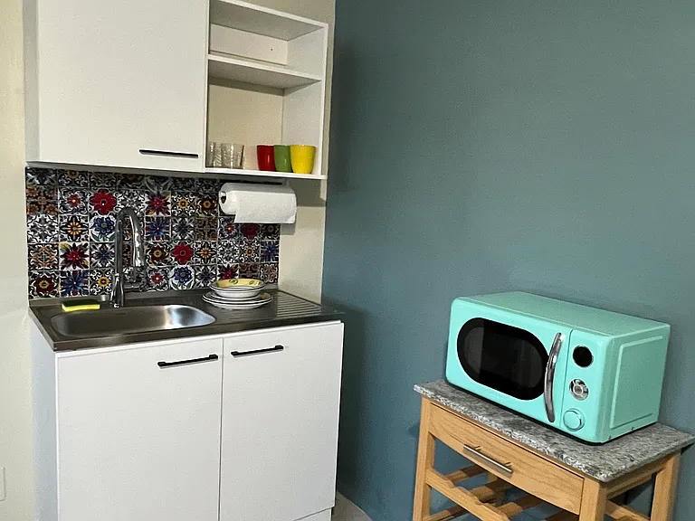 kitchen sink with cupboards and storage