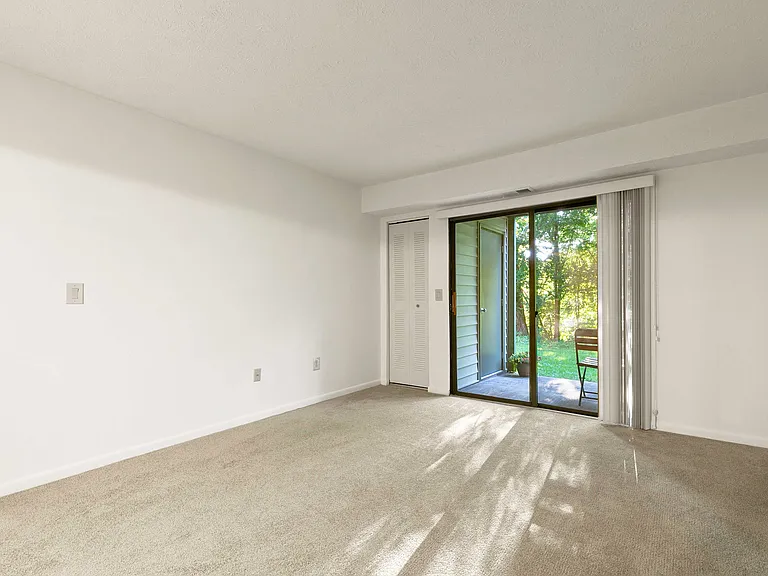 Spacious Living Room with Sliding Glass Doors Leading to Private Patio