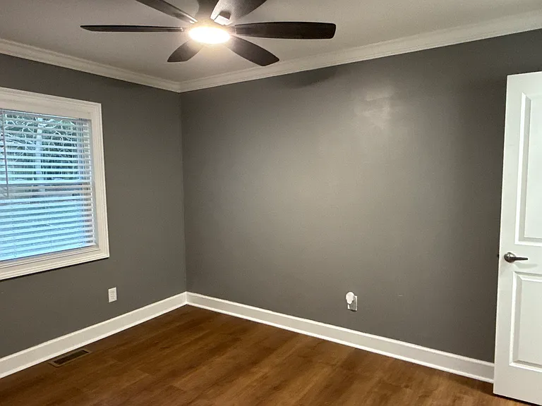 Back bedroom view from door entrance with Bluetooth ceiling fan.