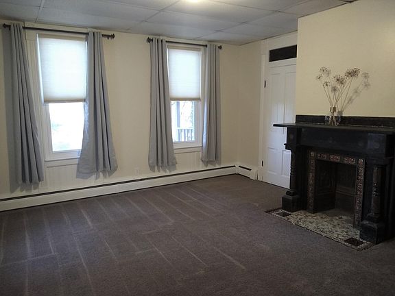 Common room with (nonfunctional) decorative fireplace. Visible door is non functional, leading to hallway and front door.