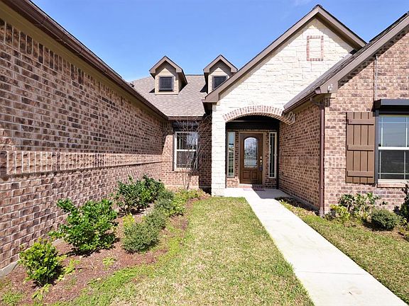 Covered entry to a beautiful beveled glass door with a Texas star