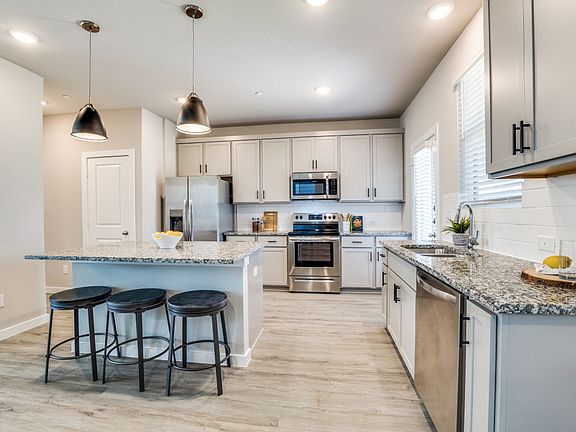 Large kitchen with island and white cabinets