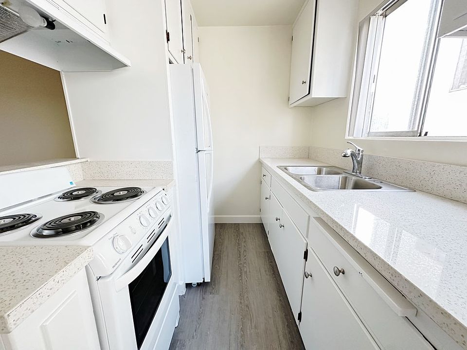 Kitchen features a new electric stove, fridge, sink with garbage disposal!