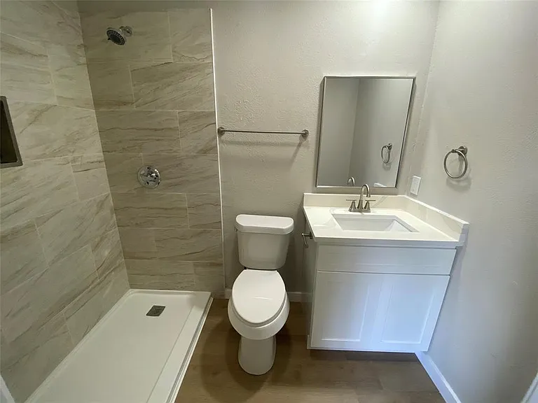 Primary private bathroom completely renovated with tile, fixtures, cabinet, sink and counter