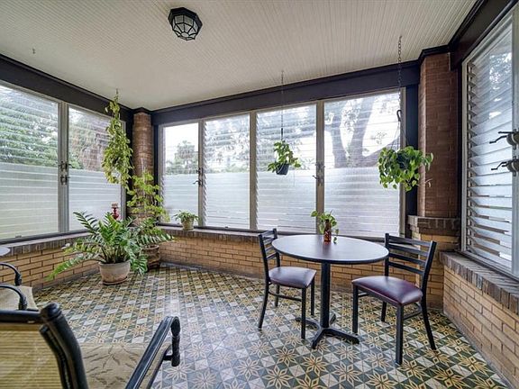 Three season porch with windows on three sides to catch balmy breezes
