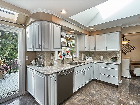 Updated kitchen. Swing open the back slider and view the backyard oasis from your eating area and garden window.
