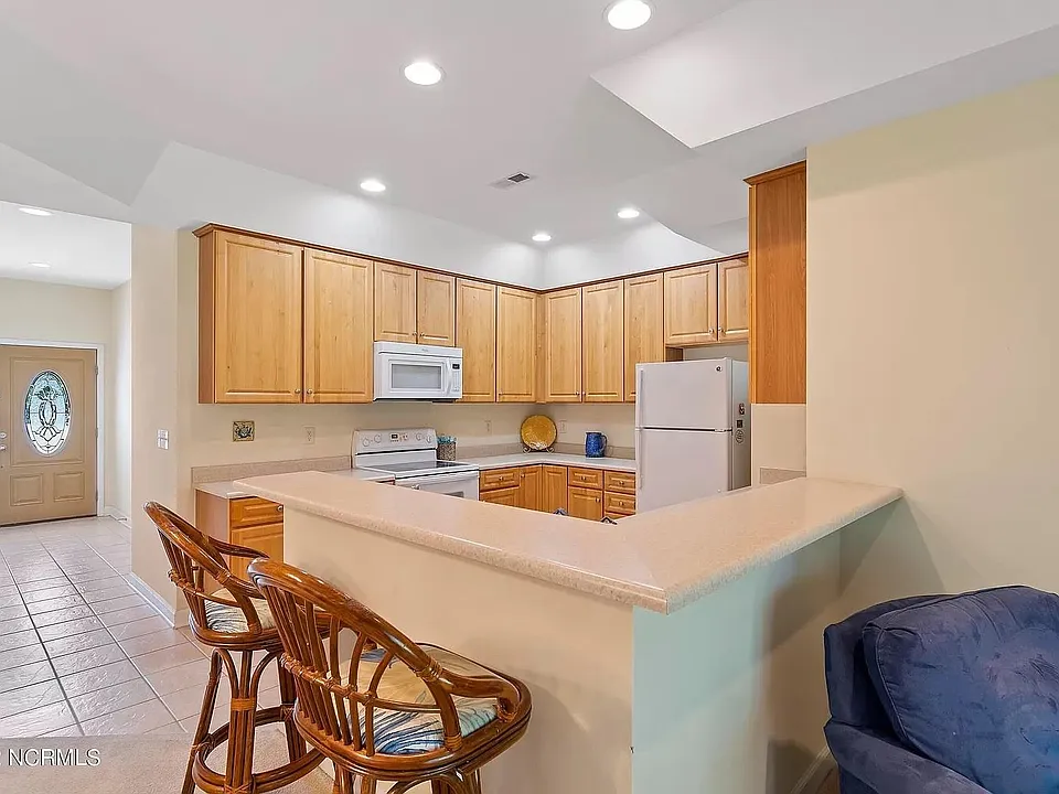 View to kitchen and entry from living room