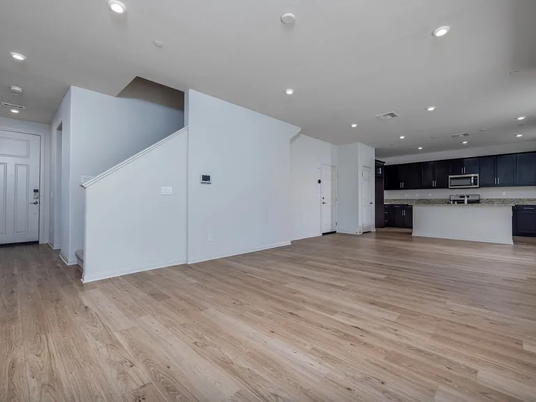 Open-concept living area with laminate flooring, recessed lighting, and easy flow to the modern kitchen_perfect for entertaining and everyday family living.